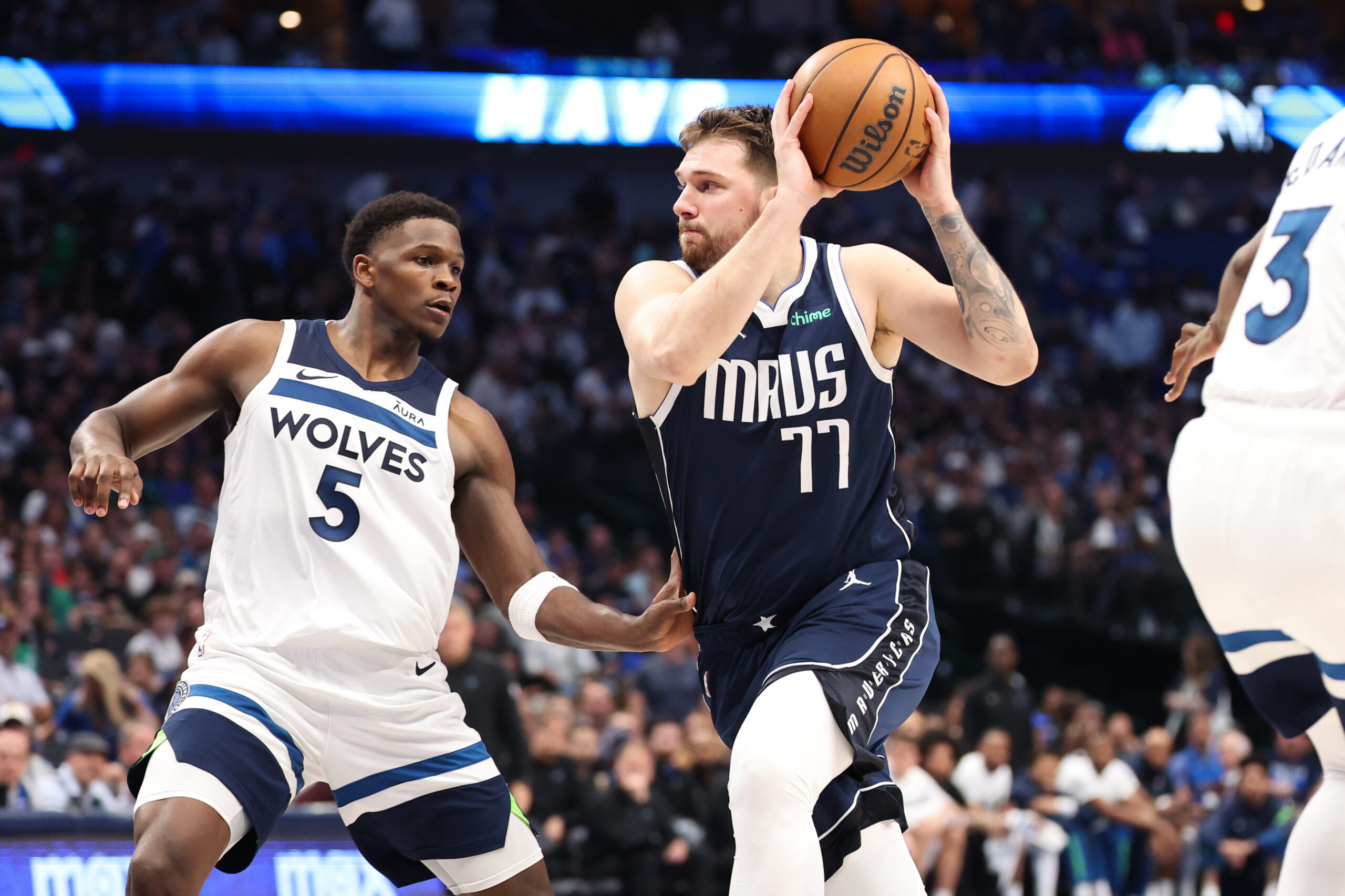 May 28, 2024; Dallas, Texas, USA; Dallas Mavericks guard Luka Doncic (77) dribbles against Minnesota Timberwolves guard Anthony Edwards (5) during the third quarter of game four of the western conference finals for the 2024 NBA playoffs at American Airlines Center.