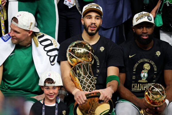 Jun 17, 2024; Boston, Massachusetts, USA; Boston Celtics forward Jayson Tatum (0) and guard Jaylen Brown (7) celebrates with the Larry O’Brian Trophy after beating the Dallas Mavericks in game five of the 2024 NBA Finals to win the NBA Championship at TD Garden.