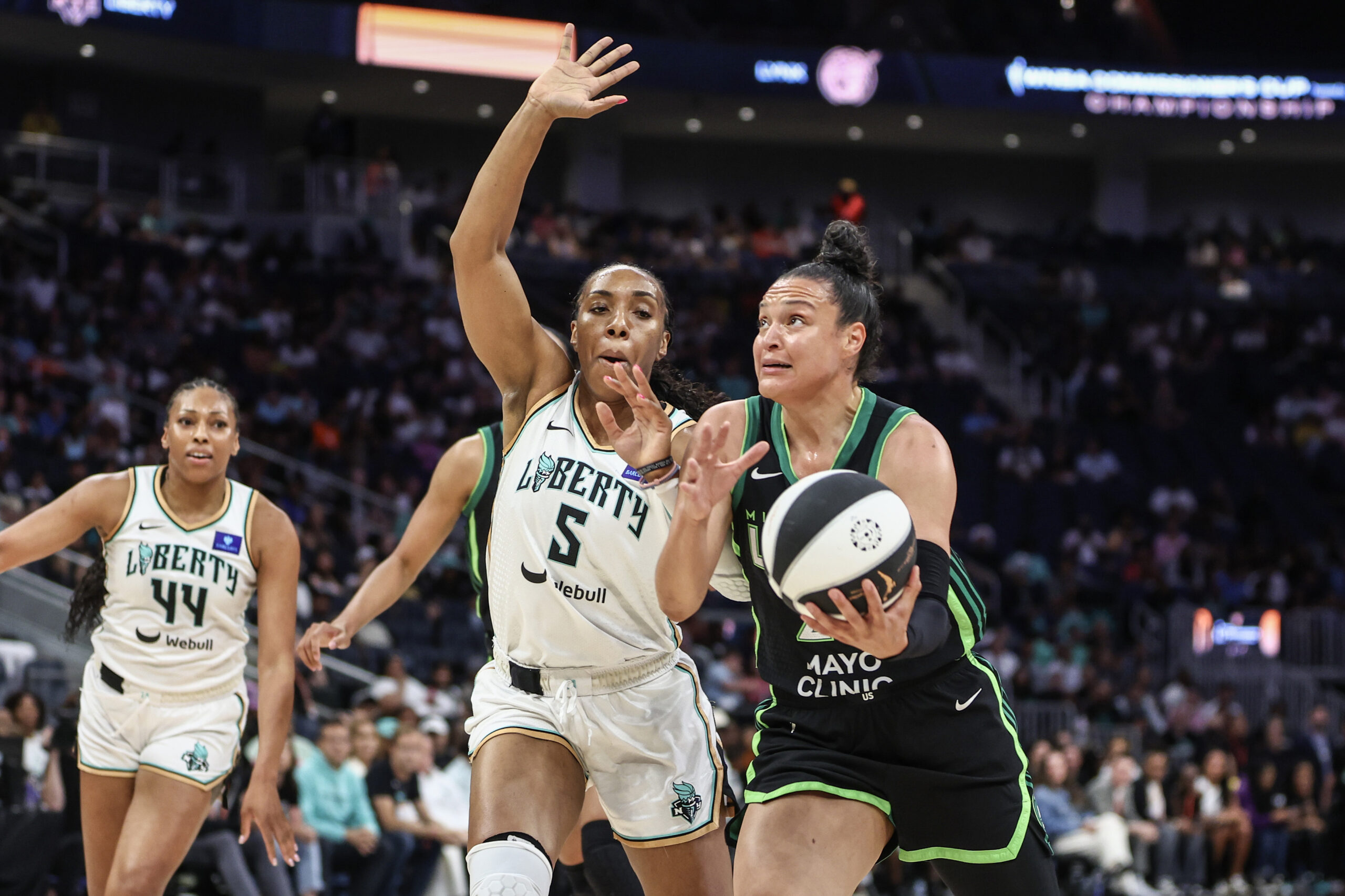 Jun 25, 2024; Belmont Park, New York, USA; Minnesota Lynx guard Kayla McBride (21) dribbles past New York Liberty forward Kayla Thornton (5) in the first quarter of the Commissioner’s Cup Championship game at UBS Arena, WNBA.