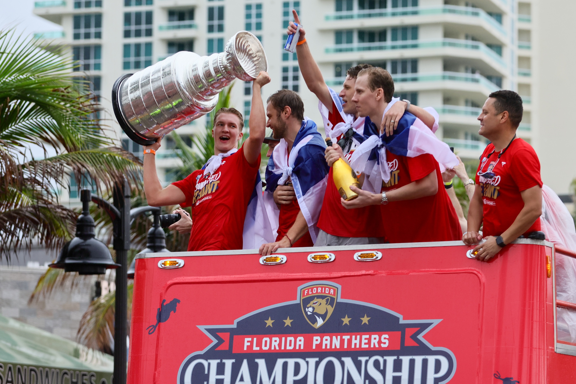 Jun 30, 2024; Fort Lauderdale, Florida, USA; Florida Panthers center Anton Lundell (left) hoists the cup during the Stanley Cup victory parade and celebration. Mandatory Credit: Sam Navarro-USA TODAY Sports