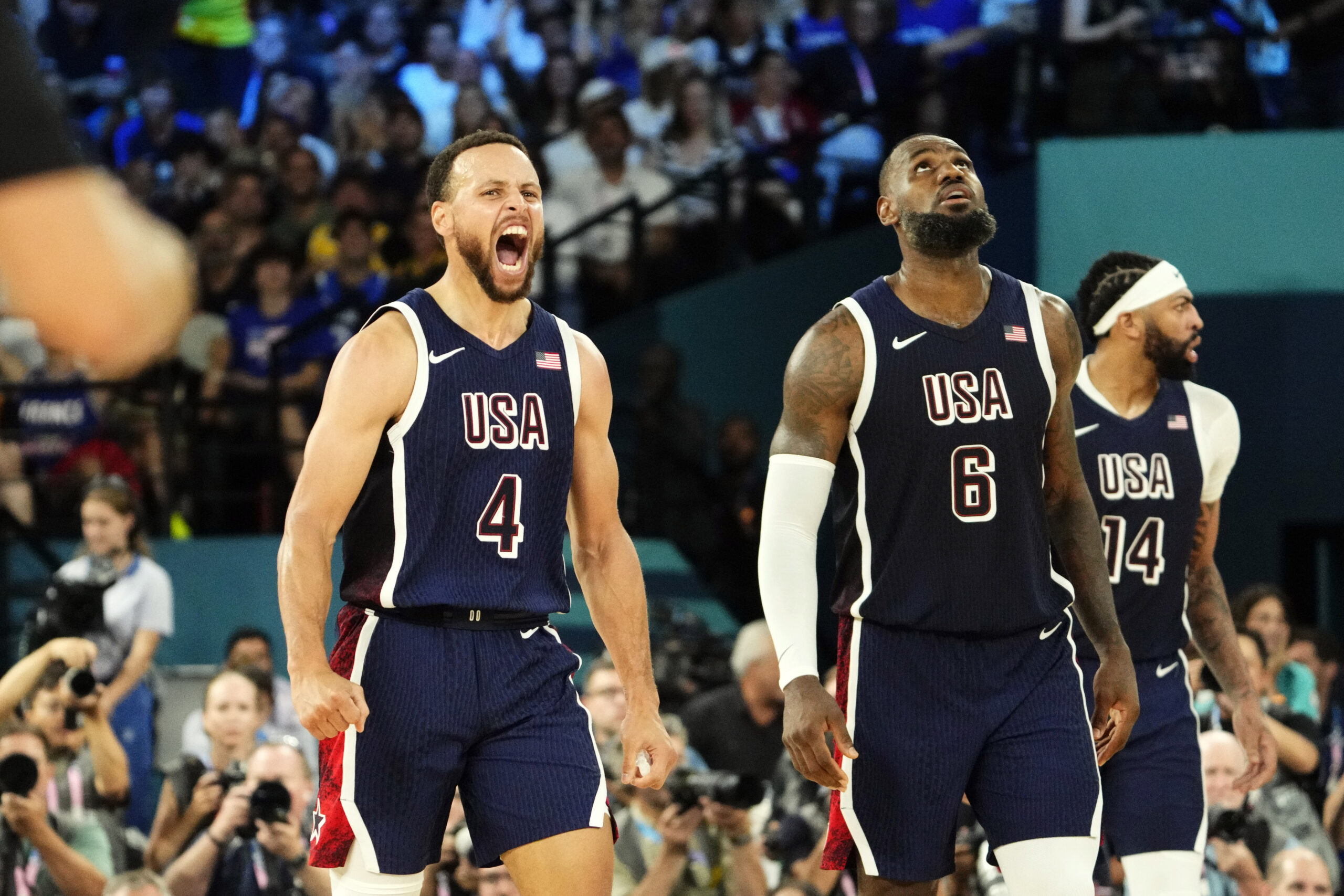 Aug 10, 2024; Paris, France; United States shooting guard Stephen Curry (4) and guard LeBron James (6) react in the second half against France in the men's basketball gold medal game during the Paris 2024 Olympic Summer Games at Accor Arena.