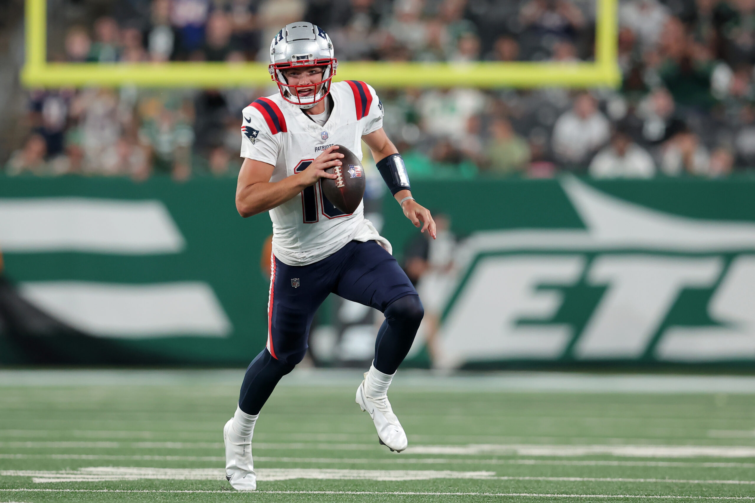 Sep 19, 2024; East Rutherford, New Jersey, USA; New England Patriots quarterback Drake Maye (10) runs with the ball against the New York Jets during the fourth quarter at MetLife Stadium.