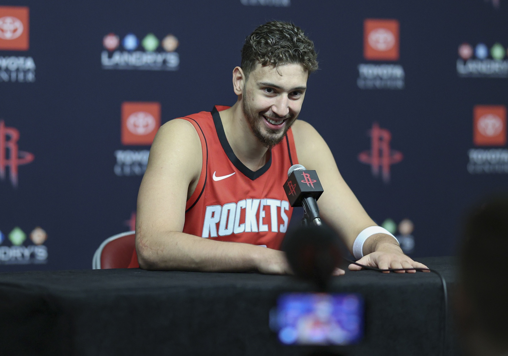 Sep 30, 2024; Houston, TX, USA; Houston Rockets center Alperen Sengun (28) speaks during Houston Rockets media day. Mandatory Credit: Troy Taormina-Imagn Images