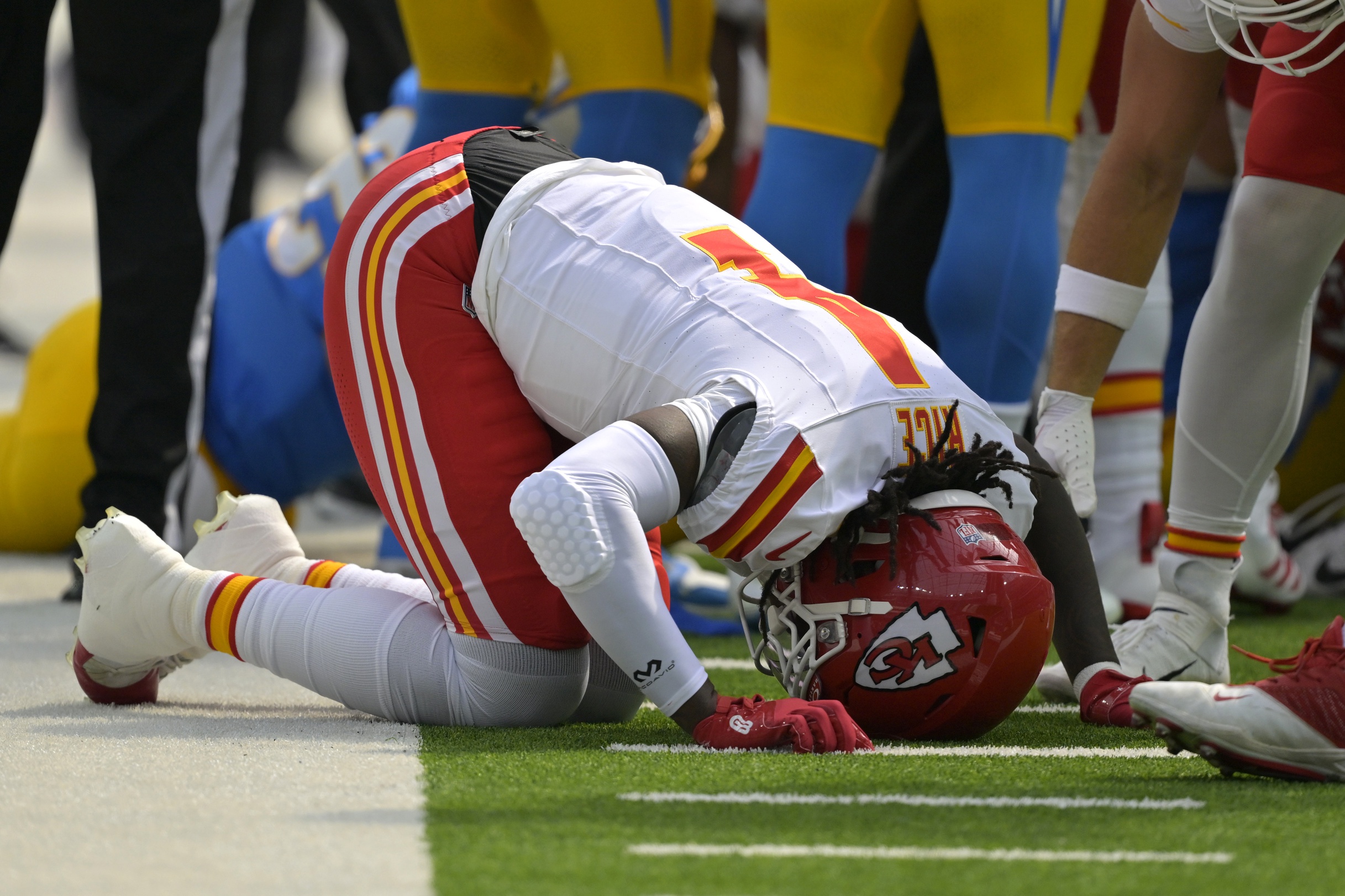 Sep 29, 2024; Inglewood, California, USA; Kansas City Chiefs wide receiver Rashee Rice (4) pounds his fist on the ground after an injury in the first half against the Los Angeles Chargers at SoFi Stadium. Mandatory Credit: Jayne Kamin-Oncea-Imagn Images