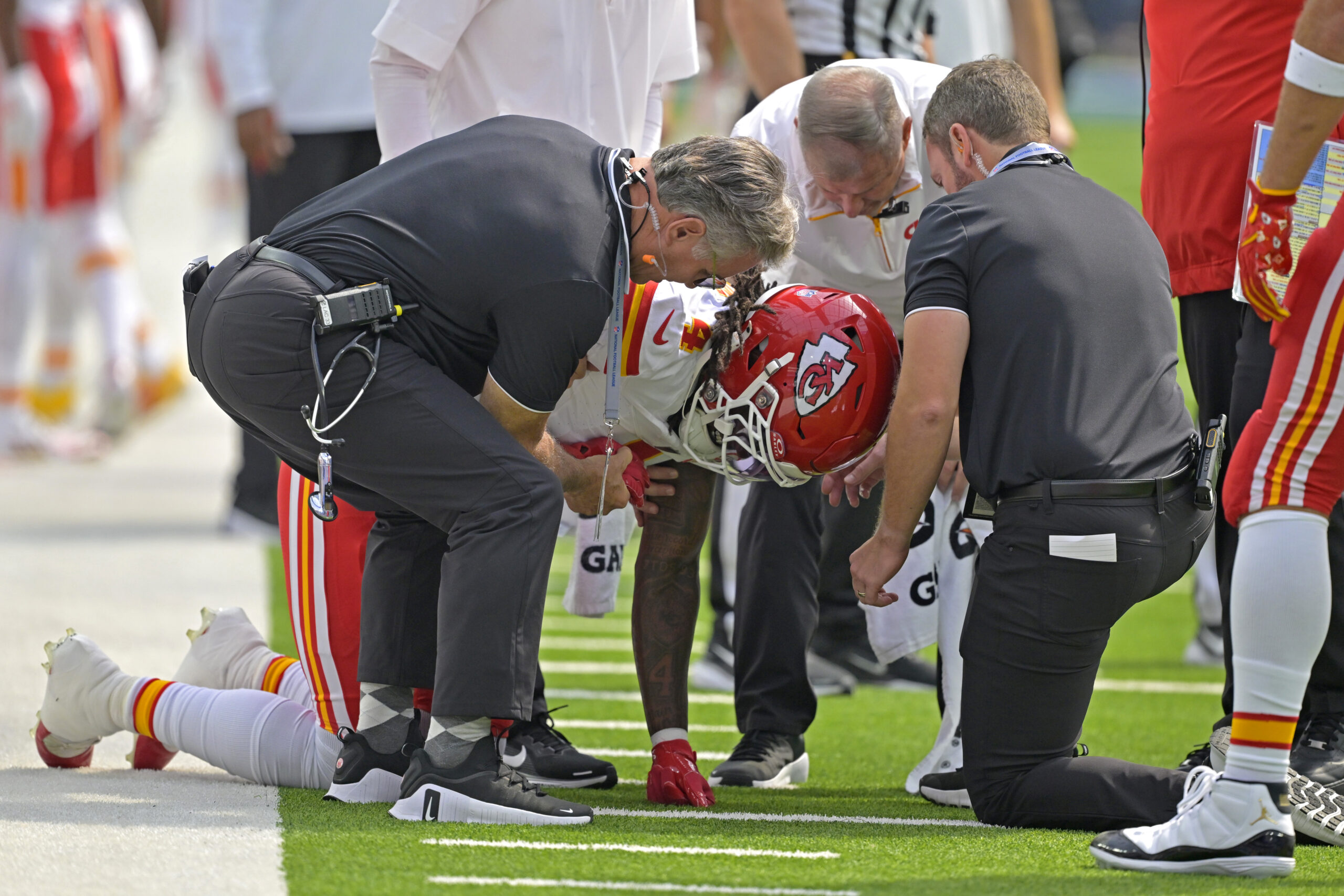 Sep 29, 2024; Inglewood, California, USA; Kansas City Chiefs wide receiver Rashee Rice (4) pounds his fist on the ground after an injury in the first half against the Los Angeles Chargers at SoFi Stadium.