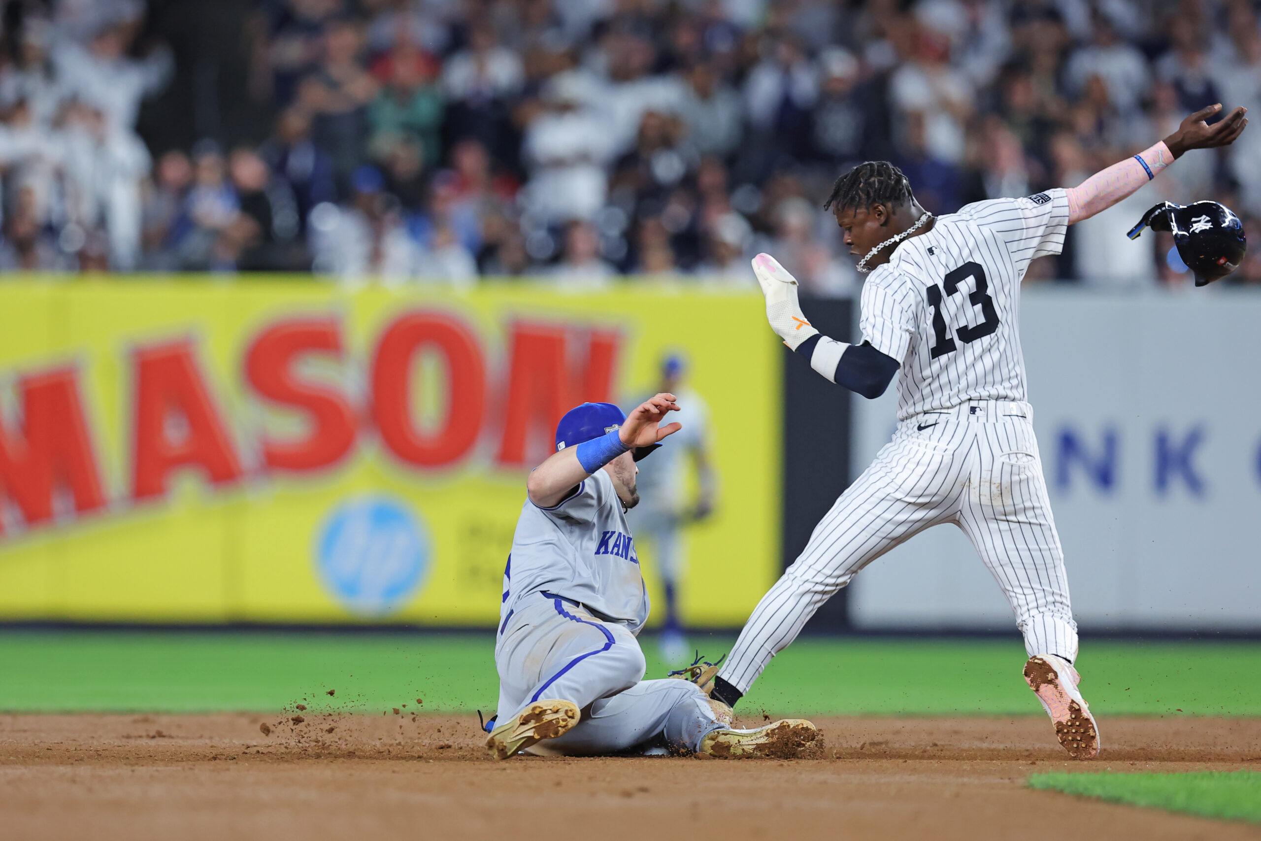 Oct 5, 2024; Bronx, New York, USA; New York Yankees third base Jazz Chisholm Jr. (13) steals second base against Kansas City Royals second base Michael Massey (19) during the seventh inning during game one of the ALDS for the 2024 MLB Playoffs at Yankee Stadium. Mandatory Credit: Brad Penner-Imagn Images