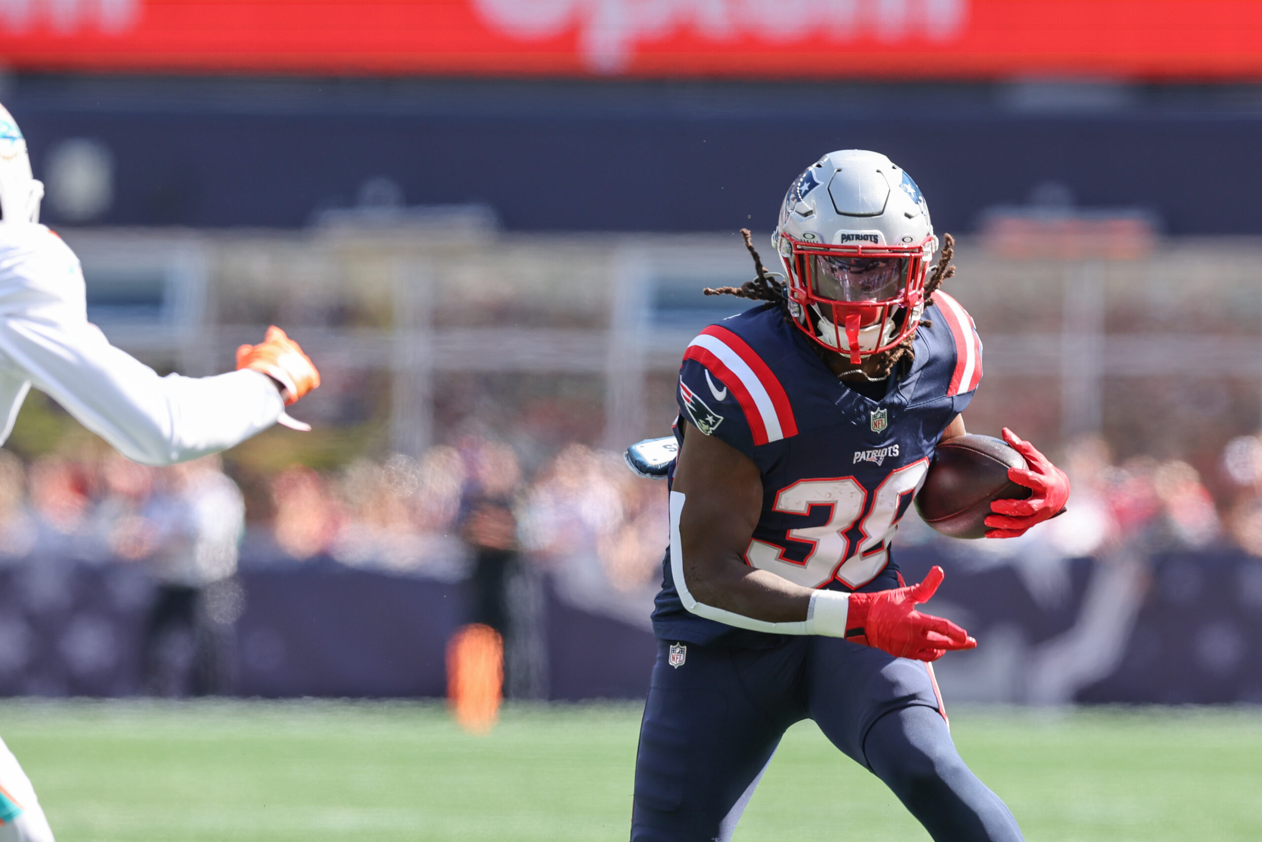 Oct 6, 2024; Foxborough, Massachusetts, USA; New England Patriots running back Rhamondre Stevenson (38) runs the ball during the first half against the Miami Dolphins at Gillette Stadium.