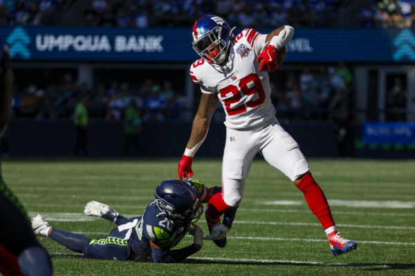 Oct 6, 2024; Seattle, Washington, USA; New York Giants running back Tyrone Tracy Jr. (29) breaks a tackle attempt by Seattle Seahawks safety Julian Love (20) during the second quarter at Lumen Field. Mandatory Credit: Joe Nicholson-Imagn Images | NFL: New York Giants at Seattle Seahawks