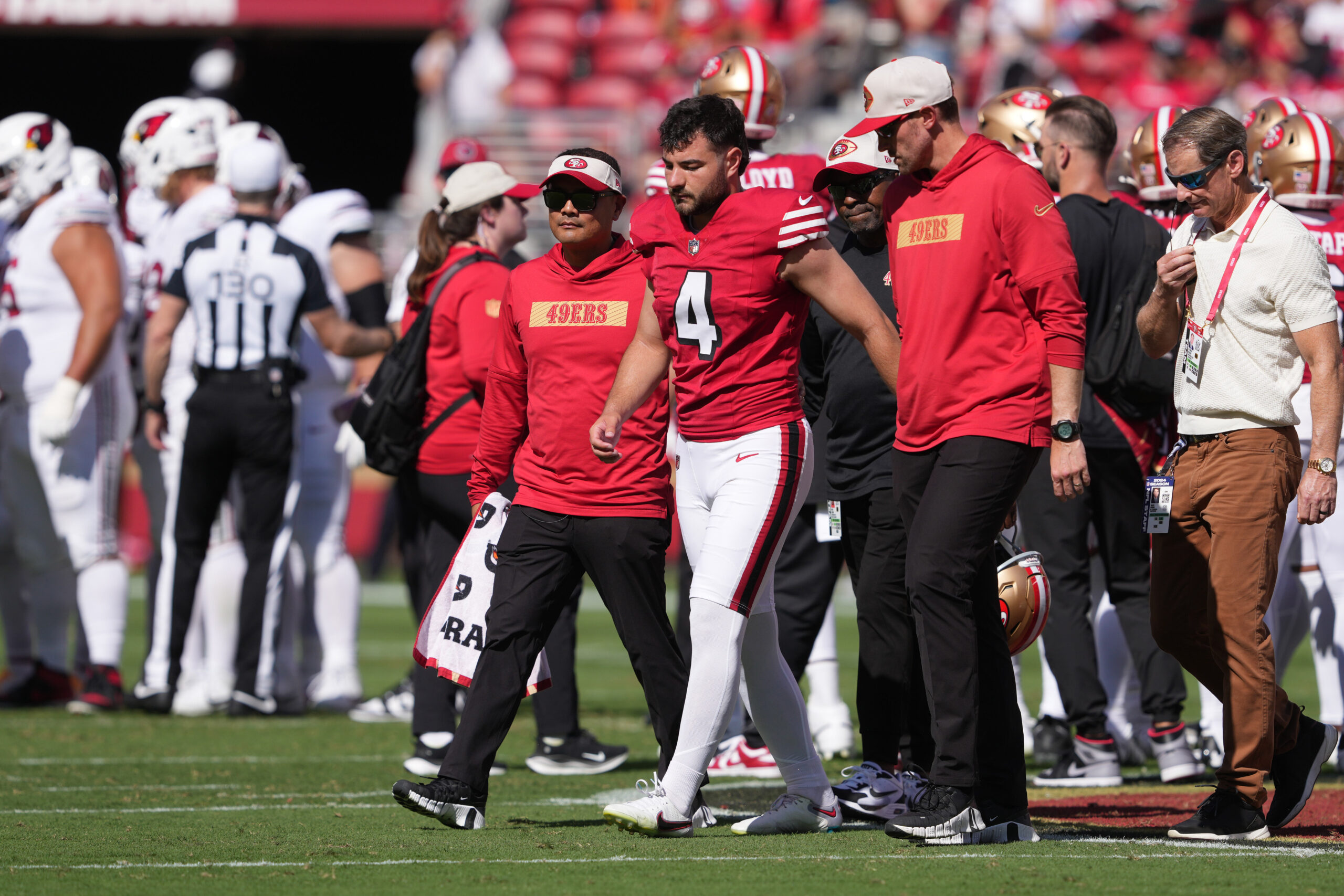 Oct 6, 2024; Santa Clara, California, USA; San Francisco 49ers place kicker Jake Moody (4) walks off of the field with medical personnel after suffering an injury against the Arizona Cardinals during the second quarter at Levi's Stadium.