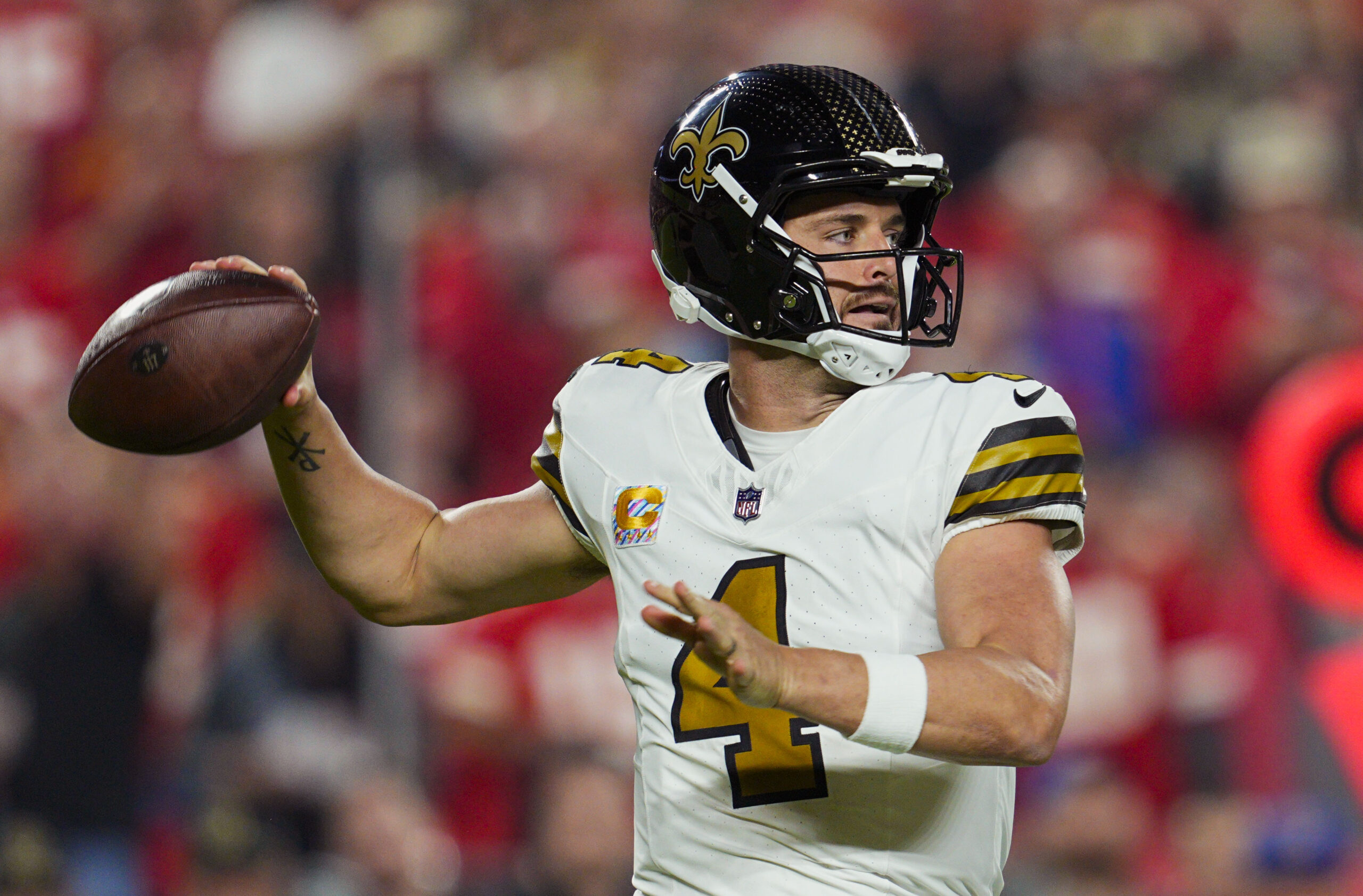 Oct 7, 2024; Kansas City, Missouri, USA; New Orleans Saints quarterback Derek Carr (4) throws a pass during the first half against the Kansas City Chiefs at GEHA Field at Arrowhead Stadium.