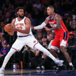 Oct 9, 2024; New York, New York, USA; NBA; New York Knicks center Karl-Anthony Towns (32) is defended by Washington Wizards forward Kyle Kuzma (33) during the first quarter at Madison Square Garden.