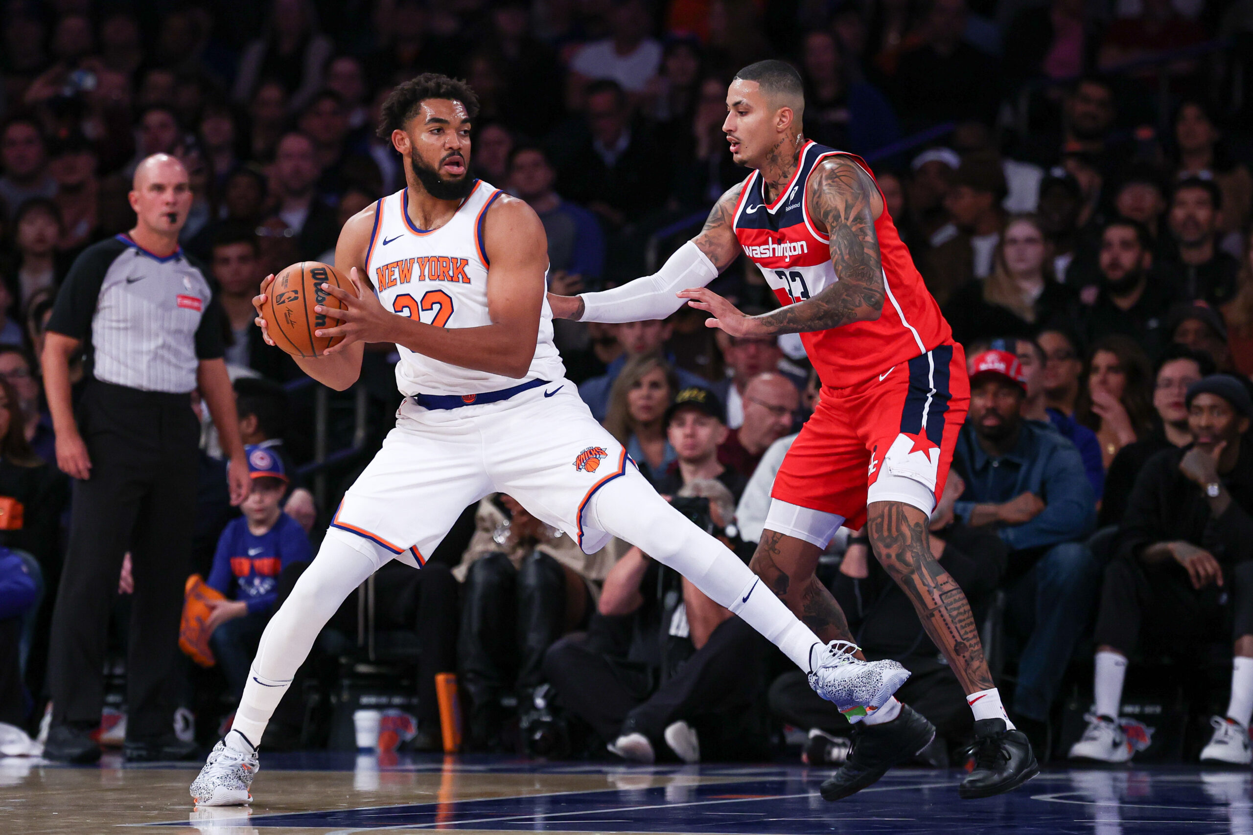 Oct 9, 2024; New York, New York, USA; NBA; New York Knicks center Karl-Anthony Towns (32) is defended by Washington Wizards forward Kyle Kuzma (33) during the first quarter at Madison Square Garden.