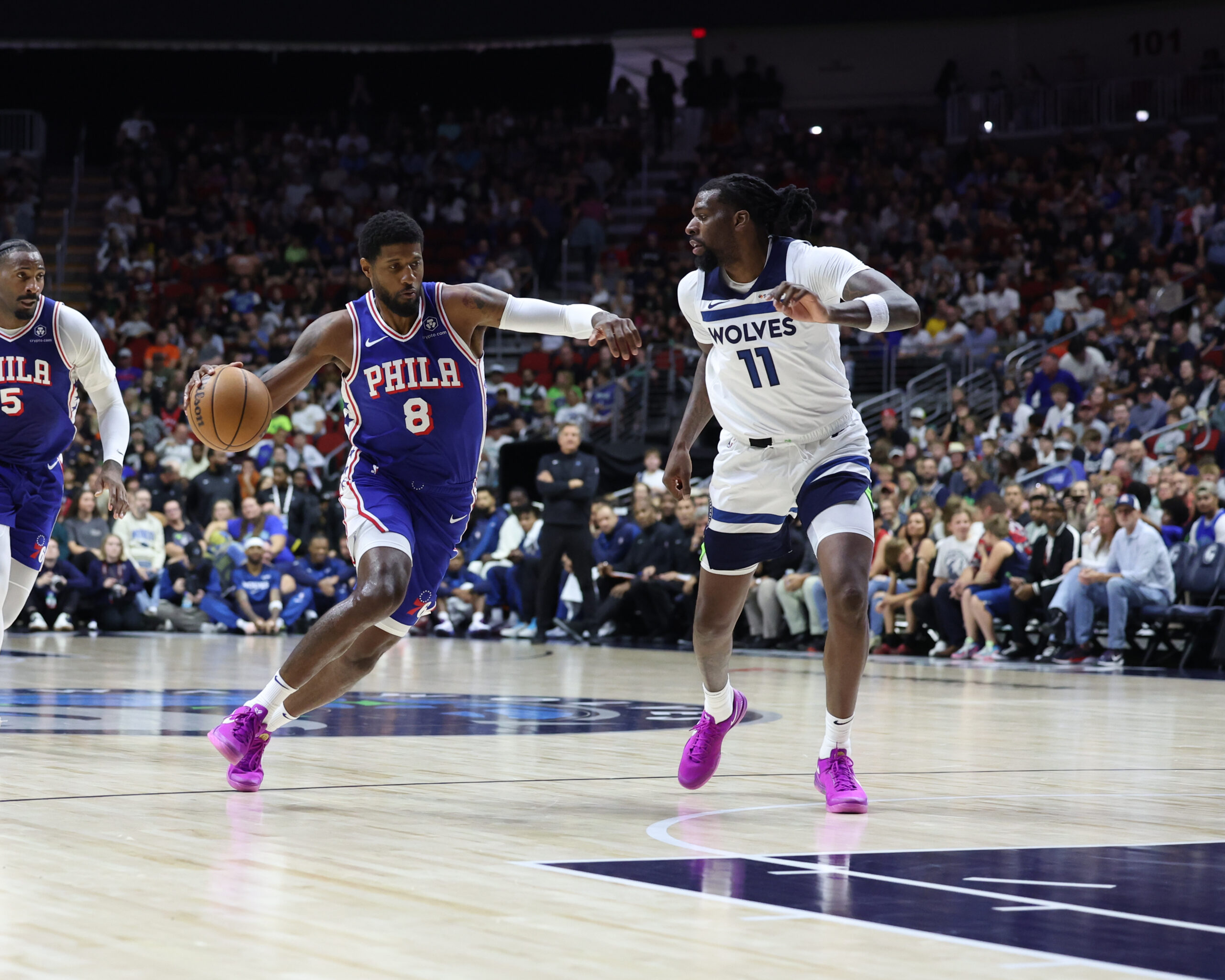 Oct 11, 2024; Des Moines, Iowa, USA; Minnesota Timberwolves center Naz Reid (11) defends Philadelphia 76ers forward Paul George (8) at Wells Fargo Arena.