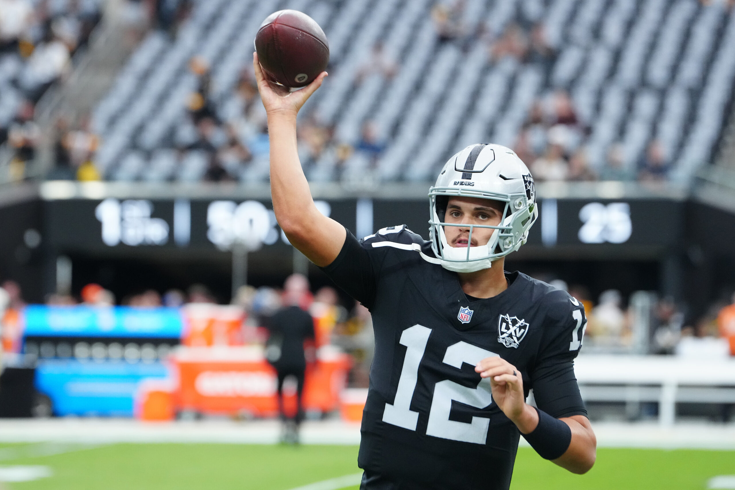 Oct 13, 2024; Paradise, Nevada, USA; Las Vegas Raiders quarterback Aidan O'Connell (12) warms up before a game against the Las Vegas Raiders at Allegiant Stadium.