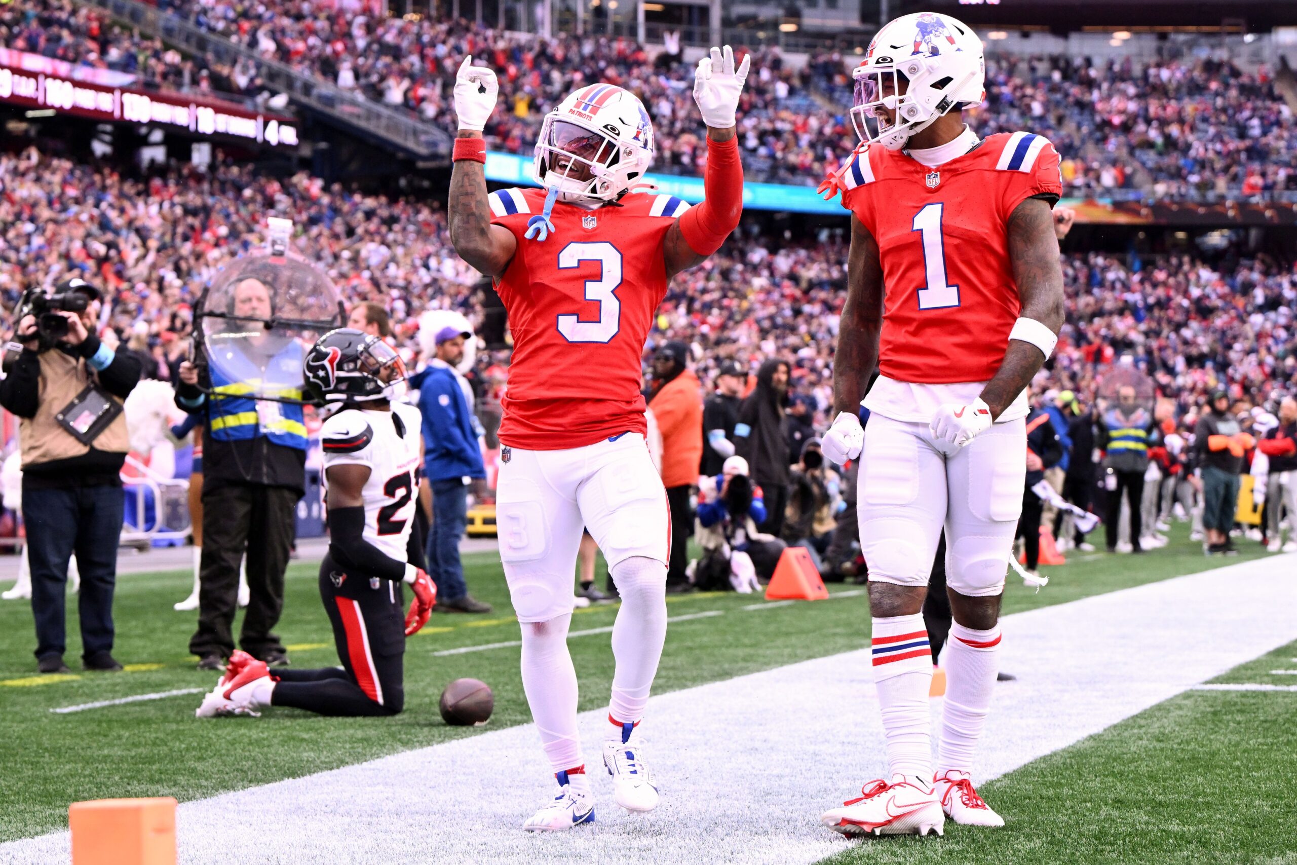 Oct 13, 2024; Foxborough, Massachusetts, USA; New England Patriots wide receiver DeMario Douglas (3) celebrates with wide receiver Ja'Lynn Polk (1) after scoring a touchdown against the Houston Texans during the second half at Gillette Stadium. Mandatory Credit: Brian Fluharty-Imagn Images