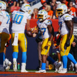 Oct 13, 2024; Denver, Colorado, USA; Los Angeles Chargers running back J.K. Dobbins (27) celebrates his touchdown carry with quarterback Justin Herbert (10) in the second quarter against the Denver Broncos at Empower Field at Mile High.