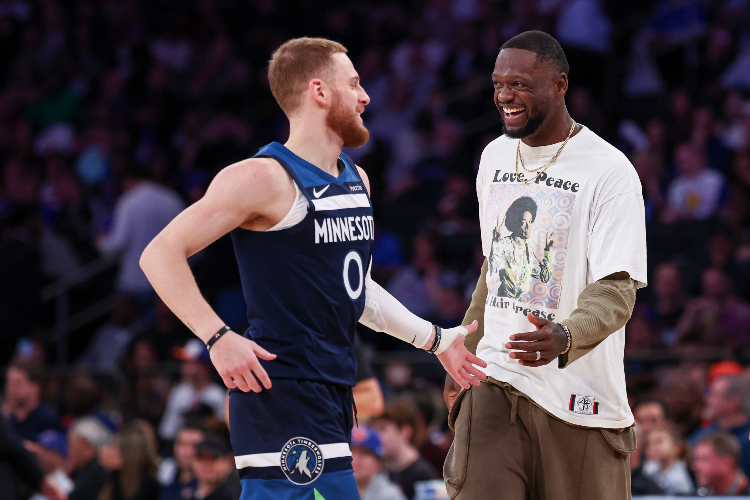 Oct 13, 2024; New York, New York, USA; Minnesota Timberwolves guard Donte DiVincenzo (0) celebrates with forward Julius Randle (30) during the first half against the New York Knicks at Madison Square Garden.