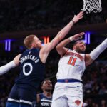 Oct 13, 2024; New York, New York, USA; New York Knicks guard Jalen Brunson (11) drives to the basket as Minnesota Timberwolves guard Donte DiVincenzo (0) defends during the first half at Madison Square Garden. Mandatory Credit: Vincent Carchietta-Imagn Images