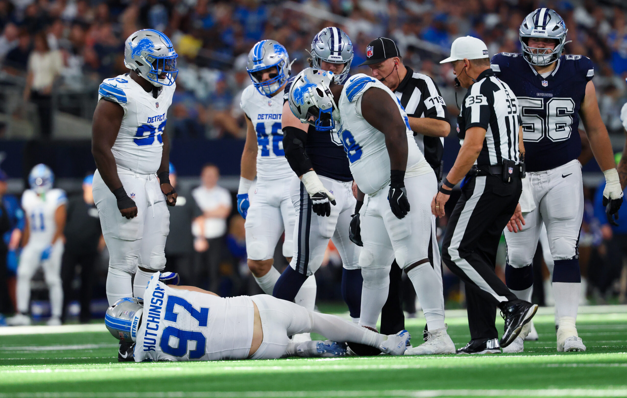 NFL: Detroit Lions at Dallas Cowboys. Oct 13, 2024; Arlington, Texas, USA; Detroit Lions defensive end Aidan Hutchinson (97) injures himself while trying to tackle Dallas Cowboys quarterback Dak Prescott (not pictured) during the second half at AT&T Stadium. Mandatory Credit: Kevin Jairaj-Imagn Images