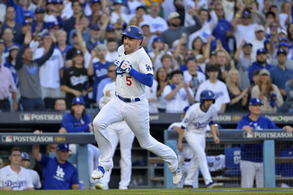 Oct 13, 2024; Los Angeles, California, USA; Los Angeles Dodgers first base Freddie Freeman (5) runs towards home plate to score a run against the New York Mets during the first inning in game one of the NLCS for the 2024 MLB Playoffs at Dodger Stadium. Mandatory Credit: Jayne Kamin-Oncea-Imagn Images