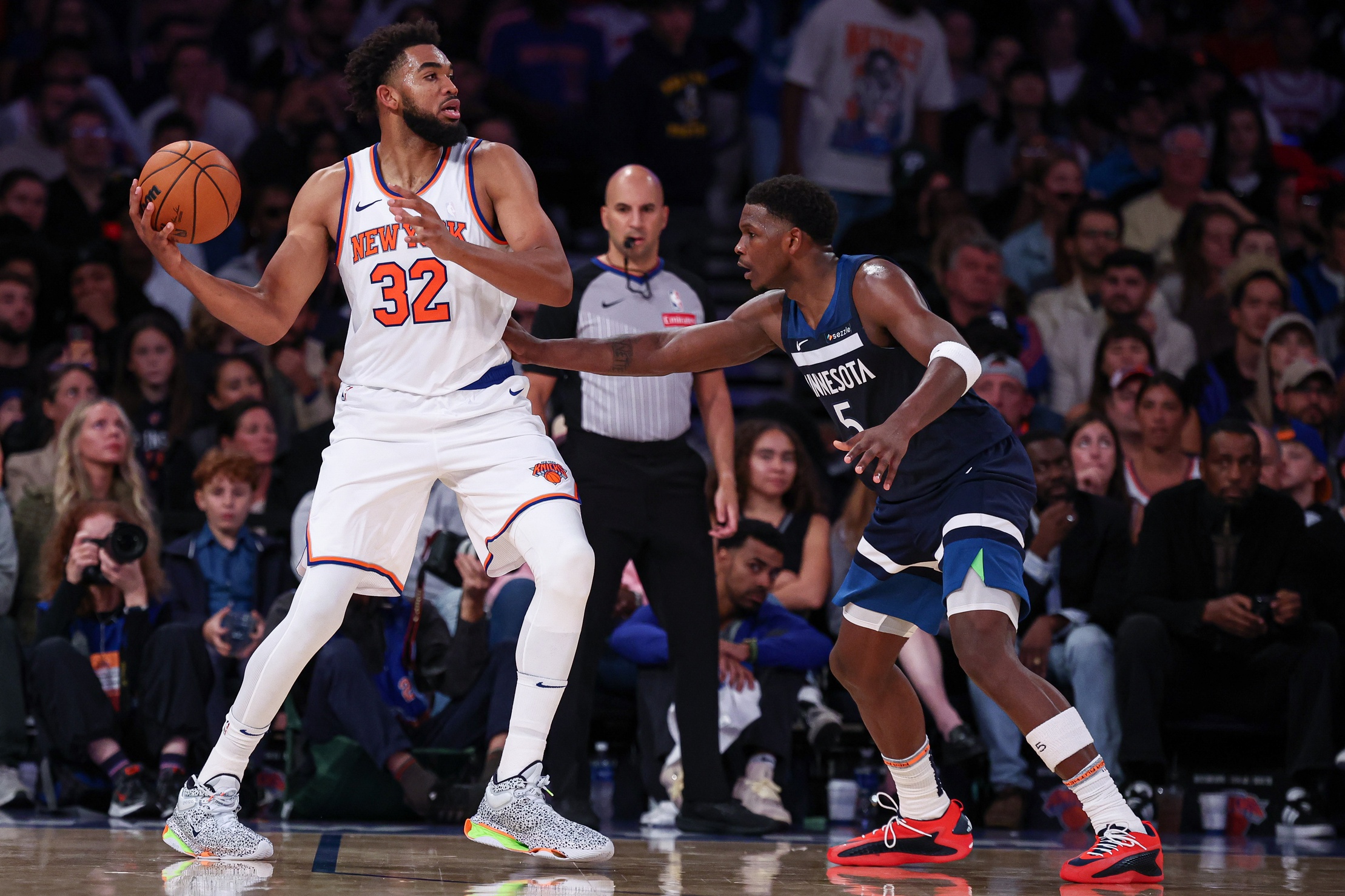 Oct 13, 2024; New York, New York, USA; New York Knicks center Karl-Anthony Towns (32) looks to pass as Minnesota Timberwolves guard Anthony Edwards (5) defends during the second half at Madison Square Garden. Mandatory Credit: Vincent Carchietta-Imagn Images