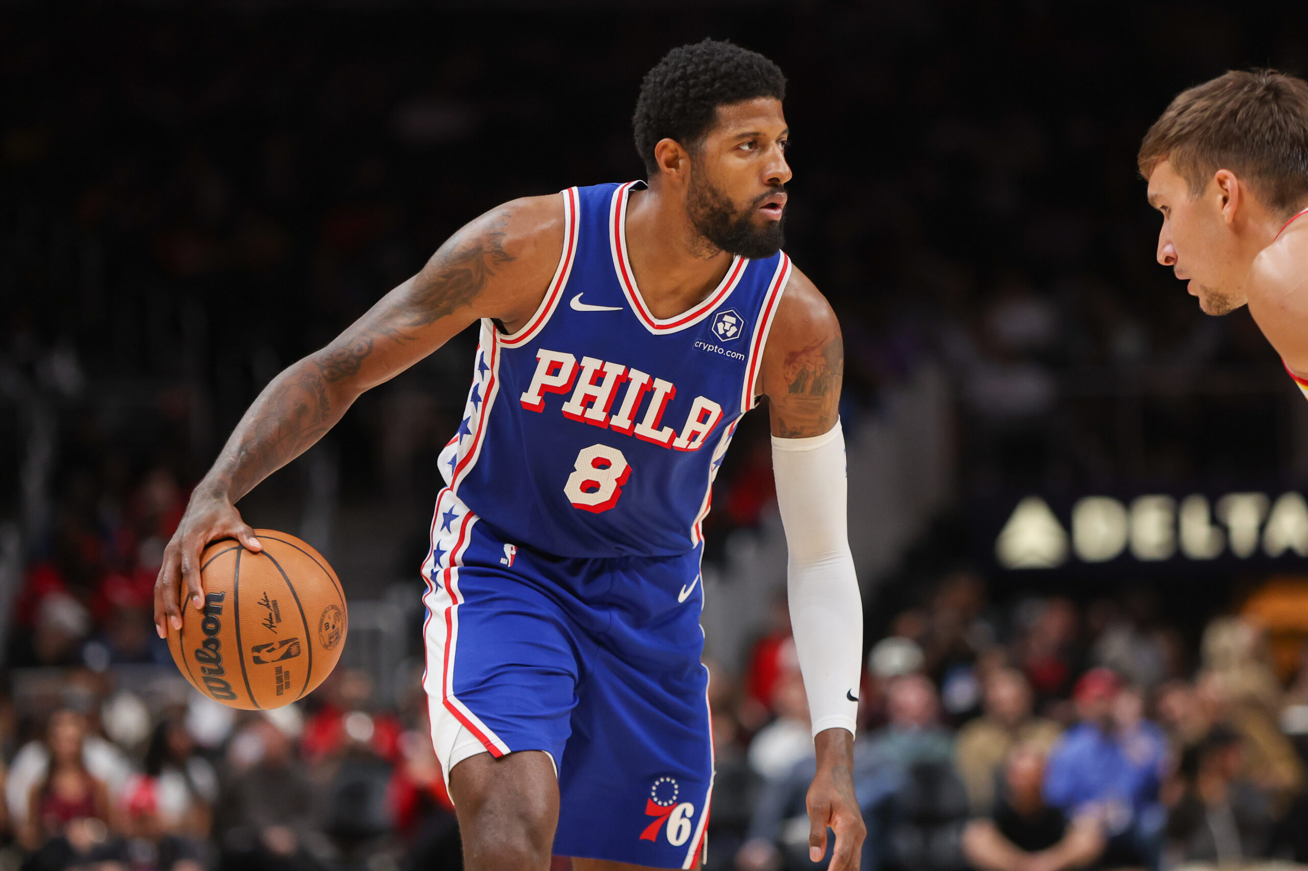 Oct 14, 2024; Atlanta, Georgia, USA; Philadelphia 76ers forward Paul George (8) dribbles against the Atlanta Hawks in the second quarter at State Farm Arena.