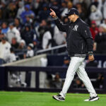 Oct 14, 2024; Bronx, New York, USA; New York Yankees manger Aaron Boone signals to the bull pen for a pitching change eighth inning against the Cleveland Guardiansin game one of the ALCS for the 2024 MLB Playoffs at Yankee Stadium. Mandatory Credit: Wendell Cruz-Imagn Images