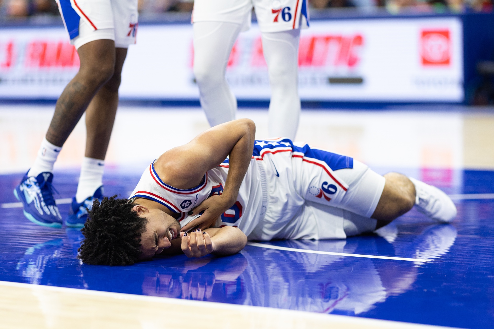 Oct 16, 2024; Philadelphia, Pennsylvania, USA; Philadelphia 76ers guard Jared McCain (20) reacts on the floor after being injured on a play against the Brooklyn Nets during the fourth quarter at Wells Fargo Center. Mandatory Credit: Bill Streicher-Imagn Images