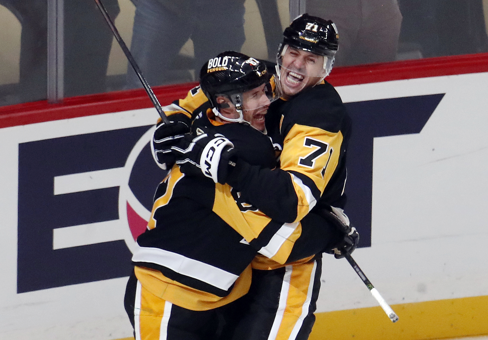 Oct 16, 2024; Pittsburgh, Pennsylvania, USA; Pittsburgh Penguins center Sidney Crosby (87) and center Evgeni Malkin (71) celebrate after Crosby scored the game winning power play goal in overtime to defeat the Buffalo Sabres at PPG Paints Arena. Mandatory Credit: Charles LeClaire-Imagn Images