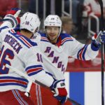 Oct 17, 2024; Detroit, Michigan, USA; New York Rangers left wing Artemi Panarin (10) receives congratulations from teammates after scoring in the first period against the Detroit Red Wings at Little Caesars Arena. Mandatory Credit: Rick Osentoski-Imagn Images