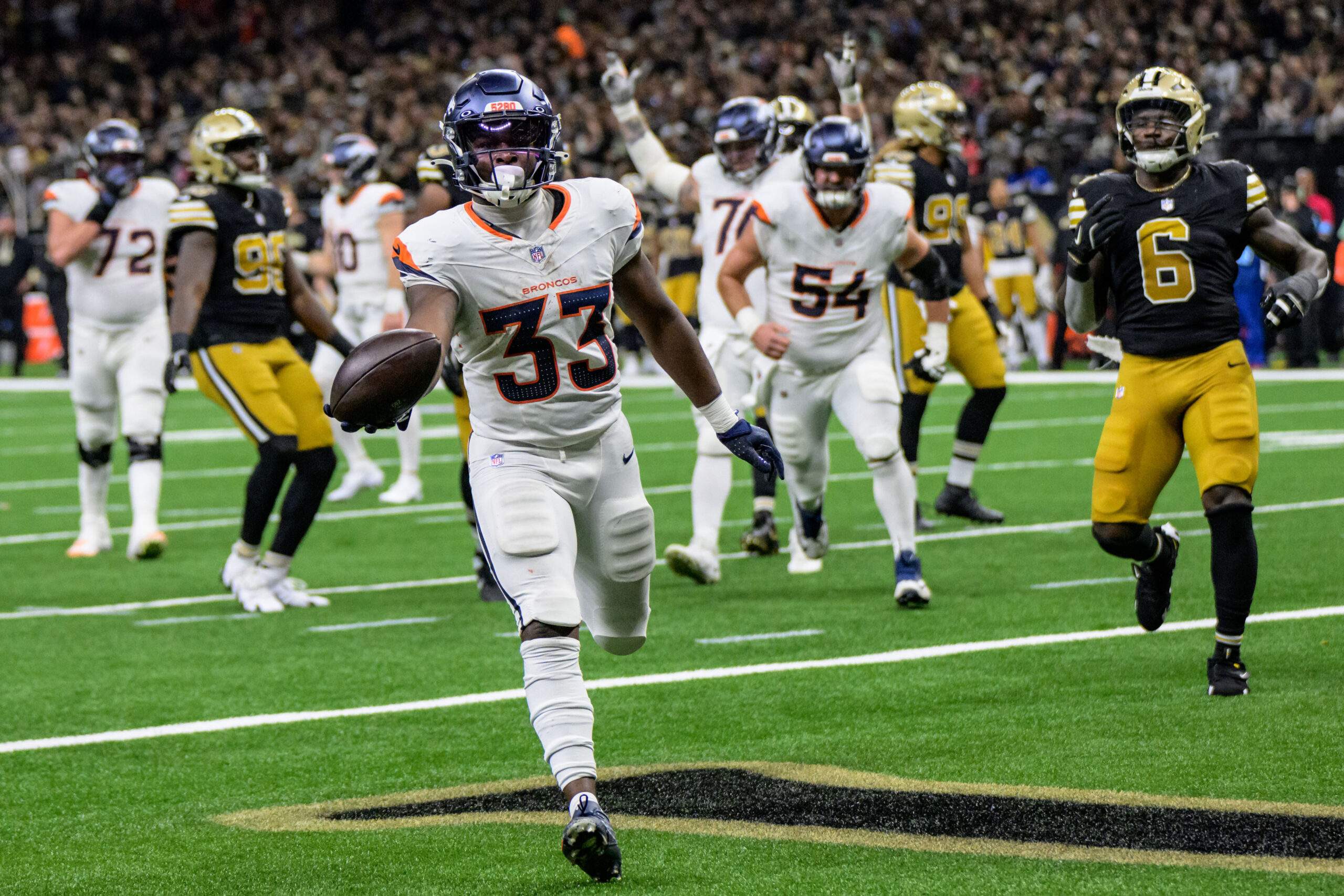 Oct 17, 2024; New Orleans, Louisiana, USA; Denver Broncos running back Javonte Williams (33) scores a touchdown against the New Orleans Saints during the second quarter at Caesars Superdome.