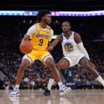 Oct 18, 2024; San Francisco, California, USA; Los Angeles Lakers guard Bronny James (9) dribbles the ball next to Golden State Warriors forward Jonathan Kuminga (00) in the second quarter at the Chase Center. Mandatory Credit: Cary Edmondson-Imagn Images