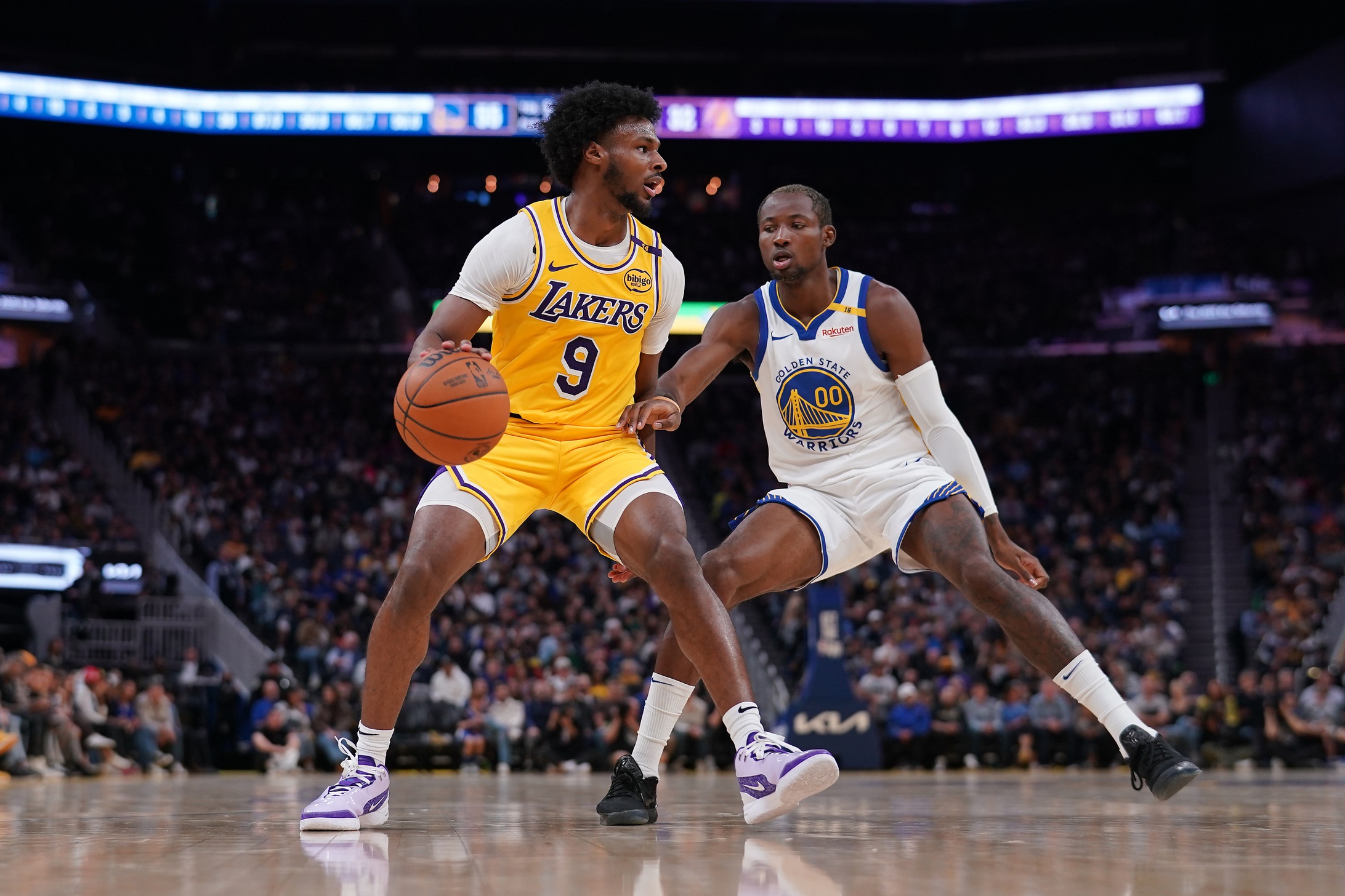 Oct 18, 2024; San Francisco, California, USA; Los Angeles Lakers guard Bronny James (9) dribbles the ball next to Golden State Warriors forward Jonathan Kuminga (00) in the second quarter at the Chase Center. Mandatory Credit: Cary Edmondson-Imagn Images