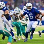 Oct 20, 2024; Indianapolis, Indiana, USA; Indianapolis Colts quarterback Anthony Richardson (5) runs the ball past Miami Dolphins defensive tackle Zach Sieler (92) during the second half at Lucas Oil Stadium.