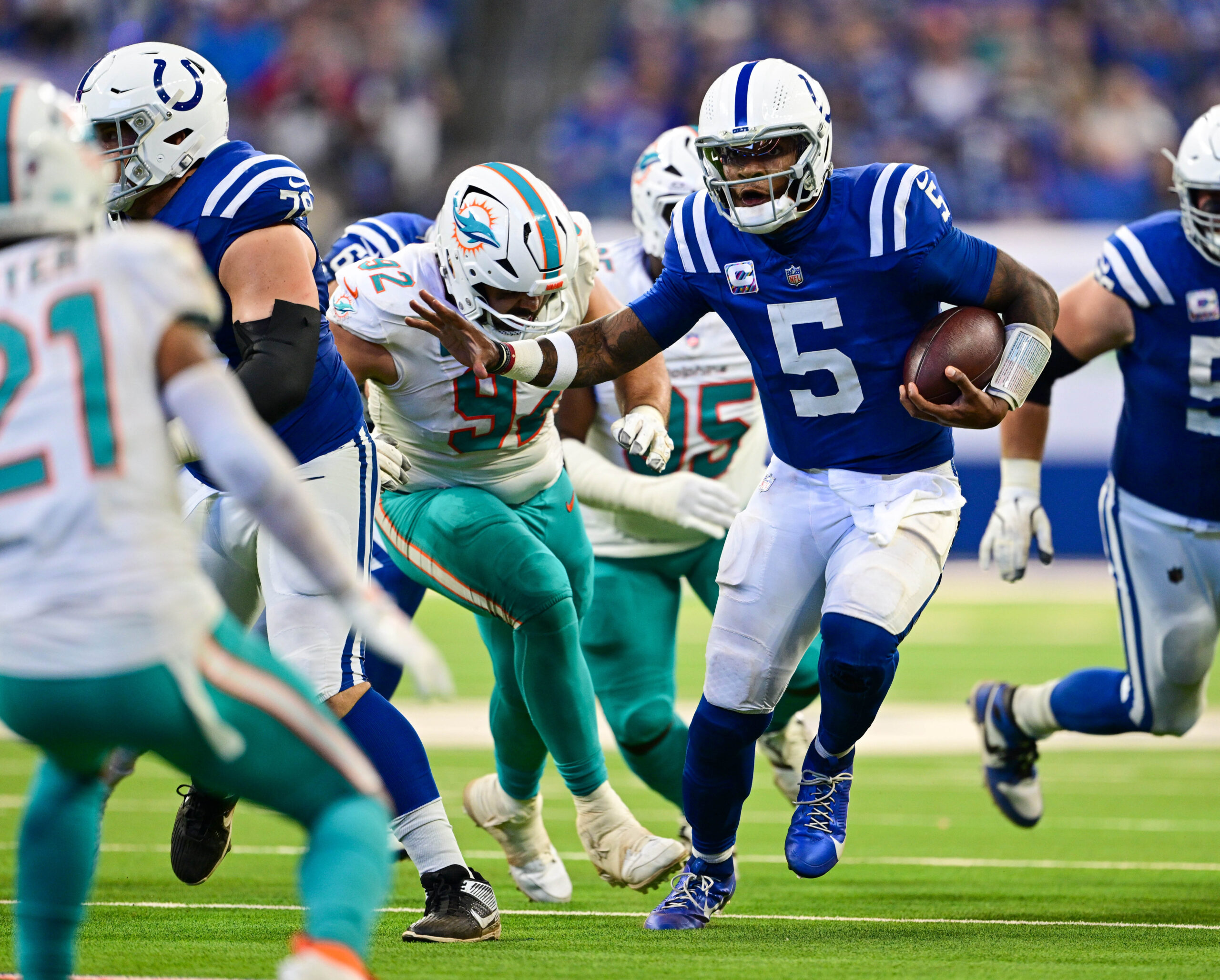 Oct 20, 2024; Indianapolis, Indiana, USA; Indianapolis Colts quarterback Anthony Richardson (5) runs the ball past Miami Dolphins defensive tackle Zach Sieler (92) during the second half at Lucas Oil Stadium.