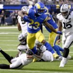 NFL: Las Vegas Raiders at Los Angeles Rams. Oct 20, 2024; Inglewood, California, USA; Los Angeles Rams running back Kyren Williams (23) breaks away from Las Vegas Raiders safety Isaiah Pola-Mao (below left) to out run quarterback Gardner Minshew (15) for a touchdown in the first half at SoFi Stadium. Mandatory Credit: Alex Gallardo-Imagn Images