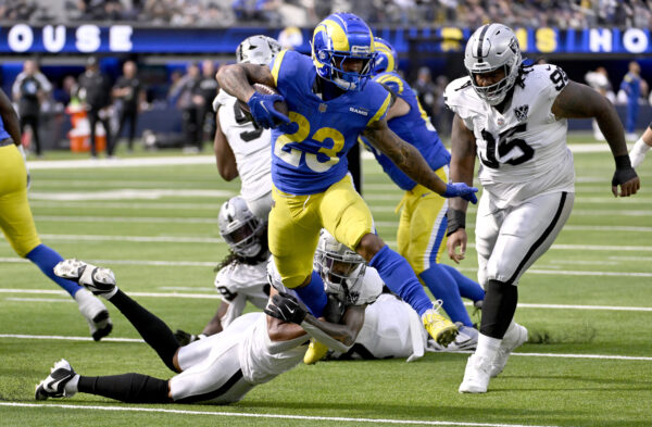 NFL: Las Vegas Raiders at Los Angeles Rams. Oct 20, 2024; Inglewood, California, USA; Los Angeles Rams running back Kyren Williams (23) breaks away from Las Vegas Raiders safety Isaiah Pola-Mao (below left) to out run quarterback Gardner Minshew (15) for a touchdown in the first half at SoFi Stadium. Mandatory Credit: Alex Gallardo-Imagn Images