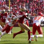 Oct 20, 2024; Santa Clara, California, USA; San Francisco 49ers wide receiver Brandon Aiyuk (11) catches a pass between Kansas City Chiefs cornerback Trent McDuffie (22) and safety Chamarri Conner (27) in the second quarter at Levi's Stadium. Mandatory Credit: Cary Edmondson-Imagn Images