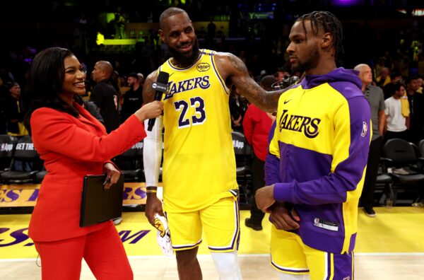 Oct 22, 2024; Los Angeles, California, USA; NBA on TNT sideline reporter Taylor Rooks interviews Los Angeles Lakers forward LeBron James (23) and guard Bronny James (9) after they defeated the Minnesota Timberwolves at Crypto.com Arena. Mandatory Credit: Jason Parkhurst-Imagn Images