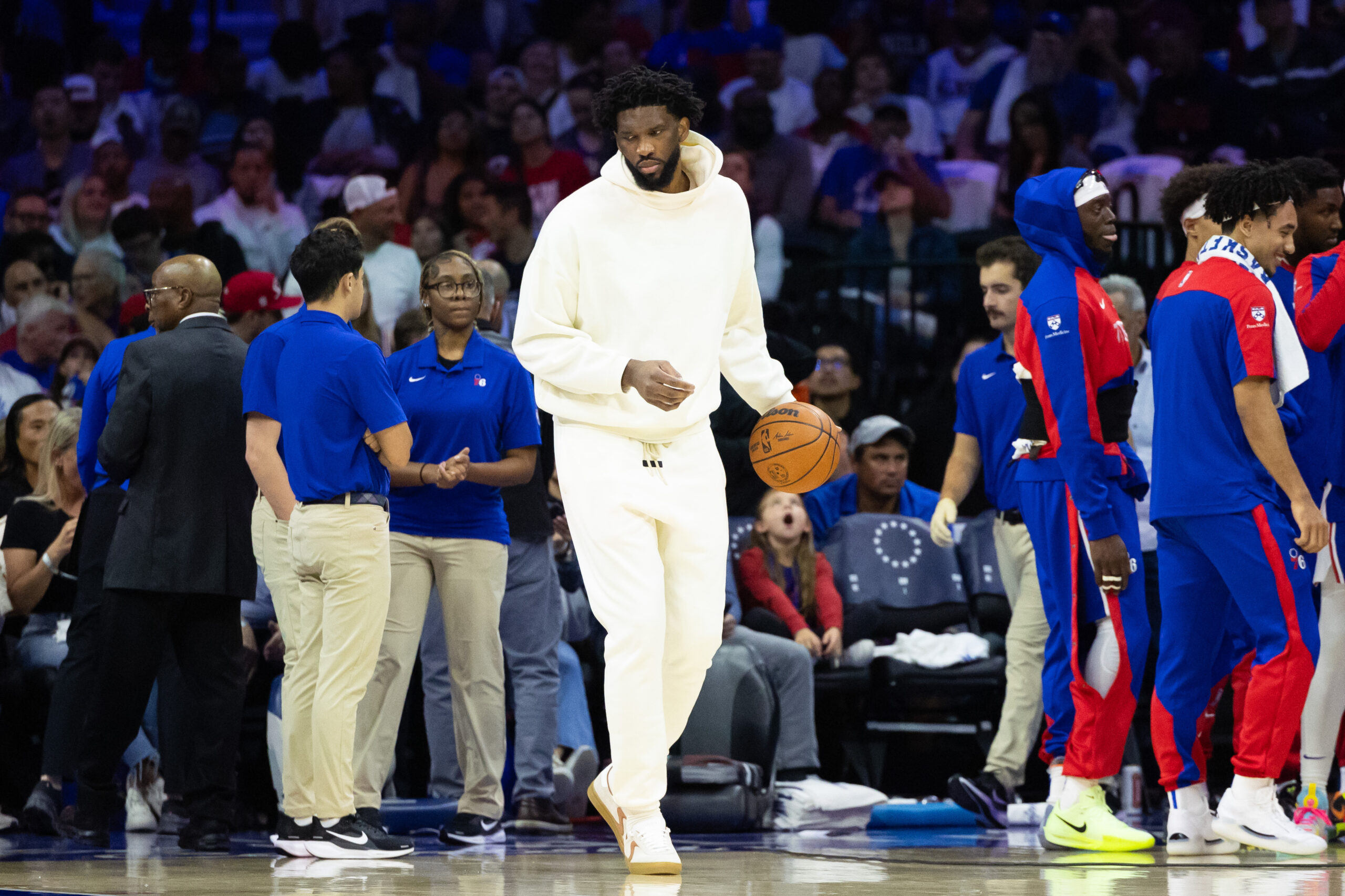 Oct 23, 2024; Philadelphia, Pennsylvania, USA; Philadelphia 76ers center Joel Embiid in plain clothes dribbles the ball during a timeout in the second quarter against the Milwaukee Bucks at Wells Fargo Center.