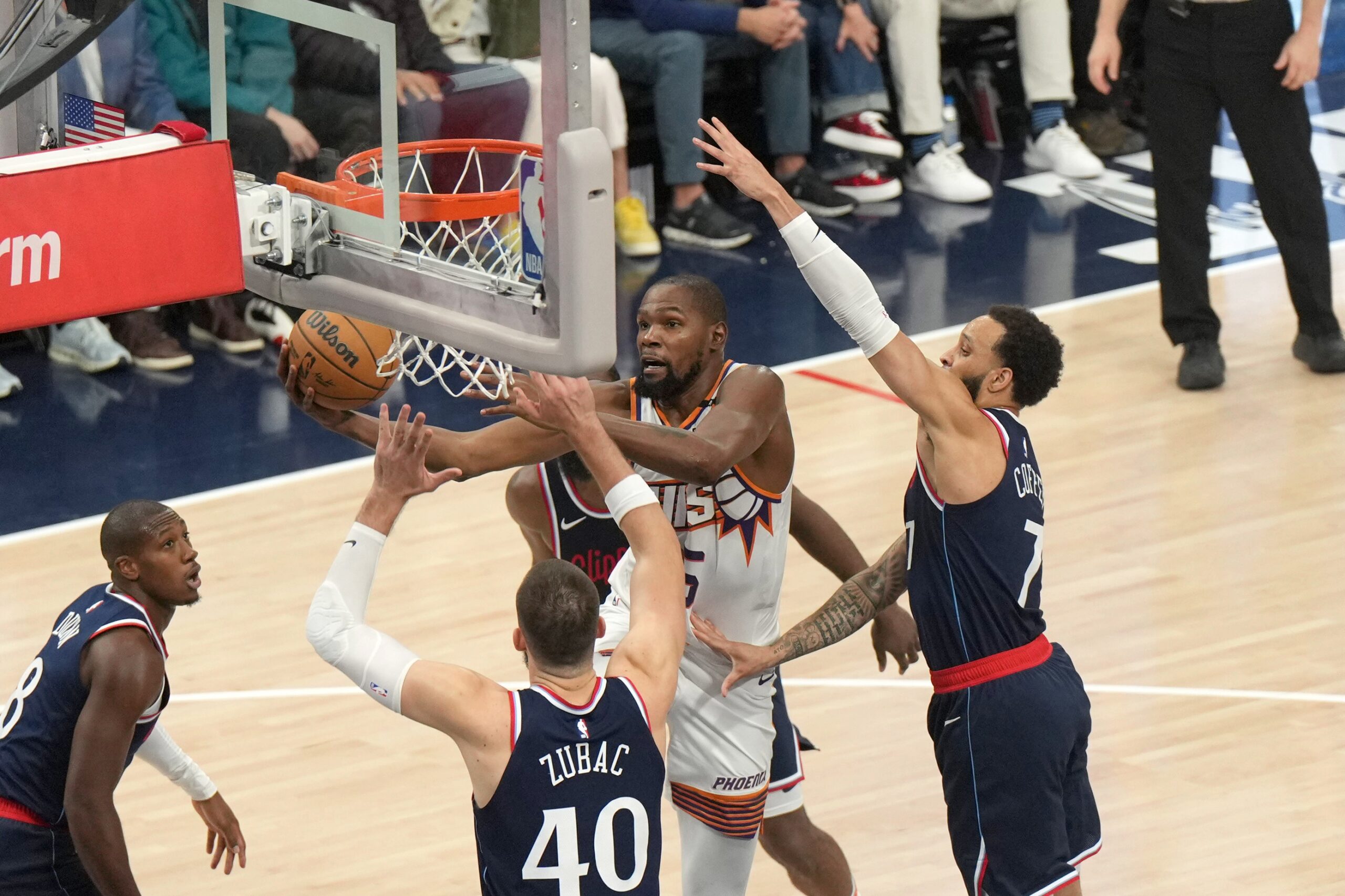 Oct 23, 2024; Inglewood, California, USA; Phoenix Suns forward Kevin Durant (35) shoots the ball against LA Clippers center Ivica Zubac (40) and guard Amir Coffey (7) in the first half at Intuit Dome.