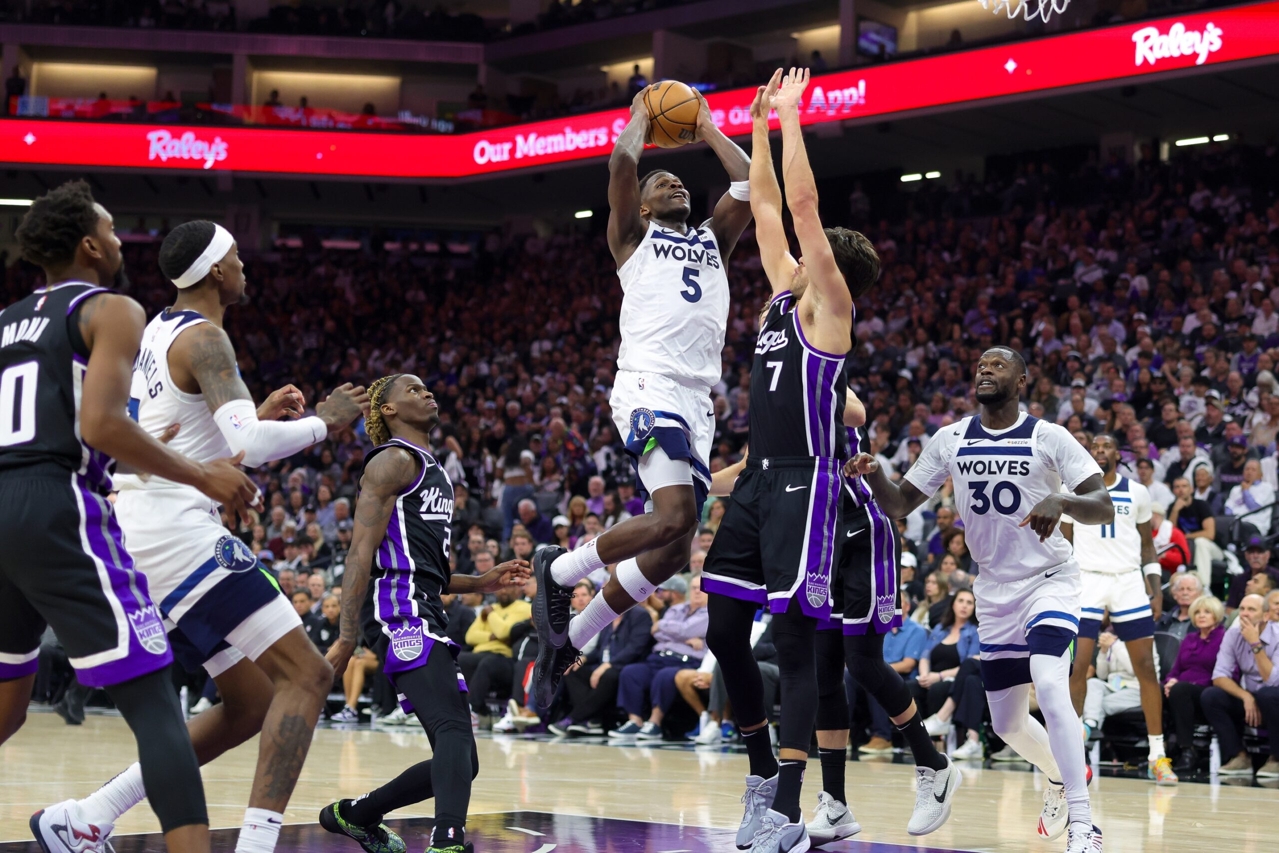 Oct 24, 2024; Sacramento, California, USA; Minnesota Timberwolves guard Anthony Edwards (5) drives to the basket against Sacramento Kings forward Doug McDermott (7) during the fourth quarter at Golden 1 Center. Mandatory Credit: Sergio Estrada-Imagn Images