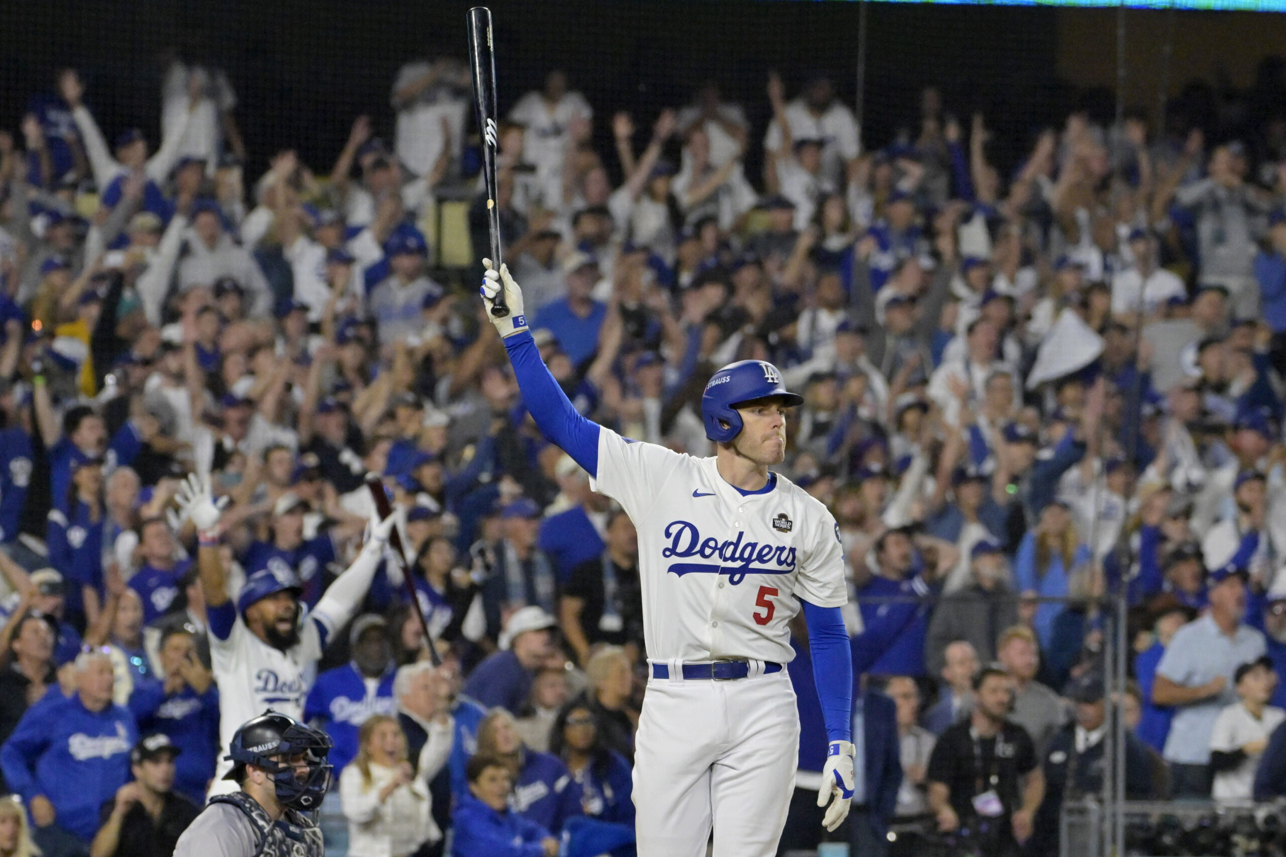 Oct 25, 2024; Los Angeles, California, USA; Los Angeles Dodgers first baseman Freddie Freeman (5) celebrates after hitting a grand slam home run in the tenth inning against the New York Yankees during game one of the 2024 MLB World Series at Dodger Stadium. Mandatory Credit: Jayne Kamin-Oncea-Imagn Images