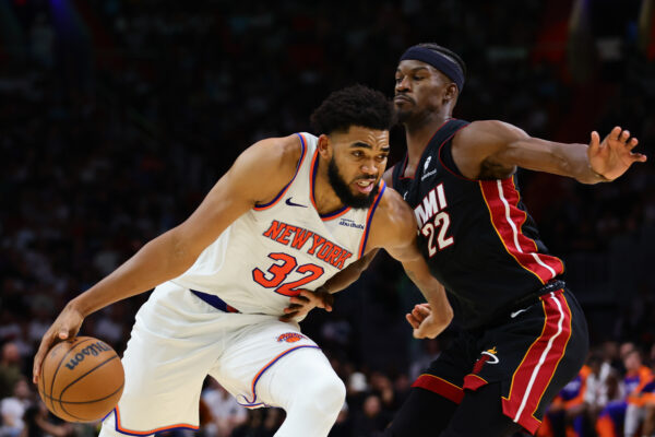 Oct 30, 2024; Miami, Florida, USA; New York Knicks center Karl-Anthony Towns (32) drives to the basketball against Miami Heat forward Jimmy Butler (22) during the fourth quarter at Kaseya Center.