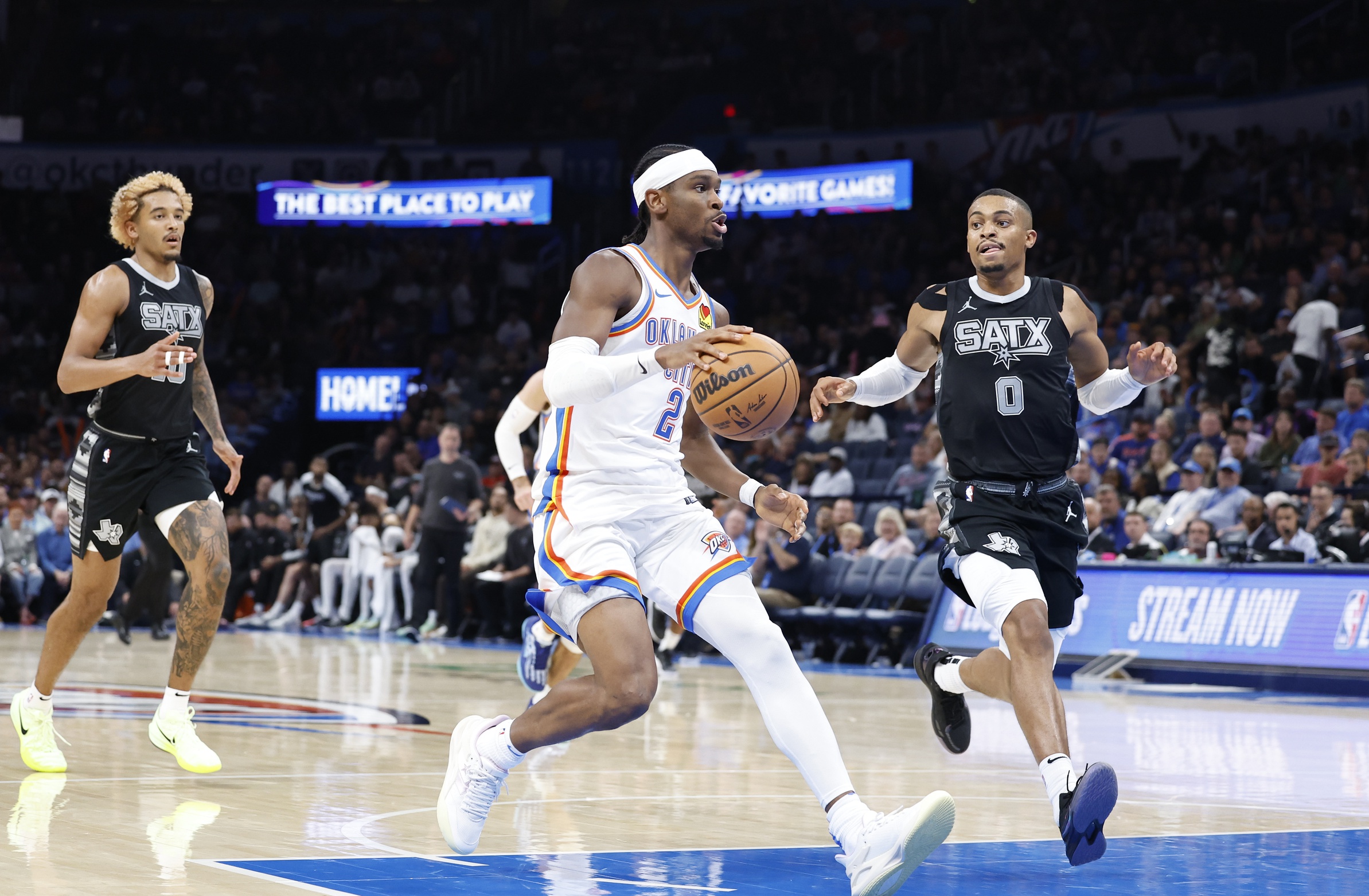 Oct 30, 2024; Oklahoma City, Oklahoma, USA; Oklahoma City Thunder guard Shai Gilgeous-Alexander (2) drives to the basket beside San Antonio Spurs forward Keldon Johnson (0) during the second half at Paycom Center. Mandatory Credit: Alonzo Adams-Imagn Images