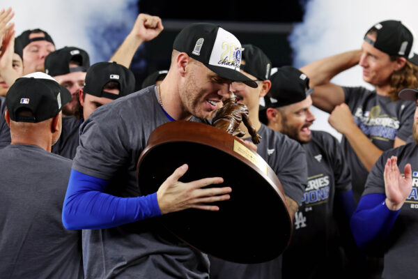 Oct 31, 2024; New York, New York, USA; Los Angeles Dodgers first baseman Freddie Freeman (5) celebrates with the Willie Mays World Series Most Valuable Player Award after being name MVP of the 2024 MLB World Series against the New York Yankees at Yankee Stadium. Mandatory Credit: Brad Penner-Imagn Images