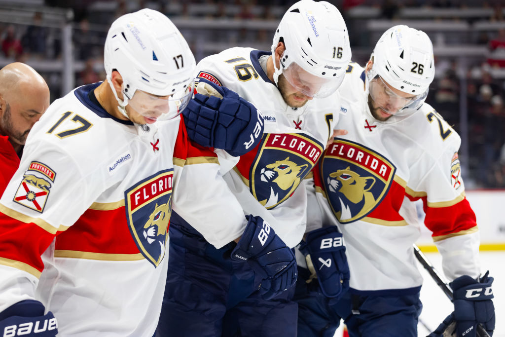 OTTAWA, ON - OCTOBER 10: Florida Panthers Center Aleksander Barkov (16) is helped off the ice by teammates Left Wing Evan Rodrigues (17) and Defenceman Uvis Balinskis (26) during third period National Hockey League action between the Florida Panthers and Ottawa Senators on October 10, 2024, at Canadian Tire Centre in Ottawa, ON, Canada