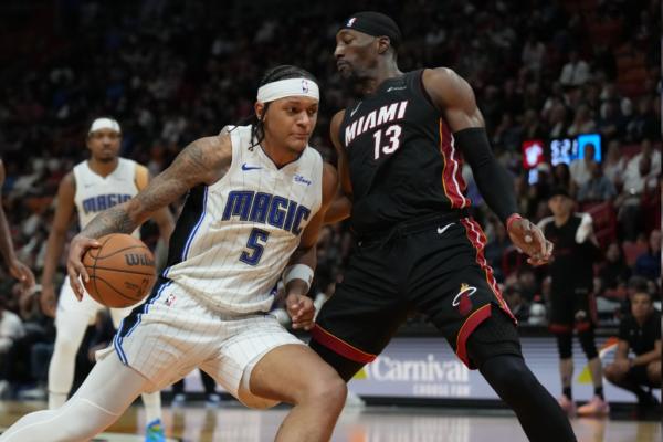 Feb 6, 2024; Miami, Florida, USA; Orlando Magic forward Paolo Banchero (5) drives to the basket as Miami Heat center Bam Adebayo (13) defends during the second half at Kaseya Center