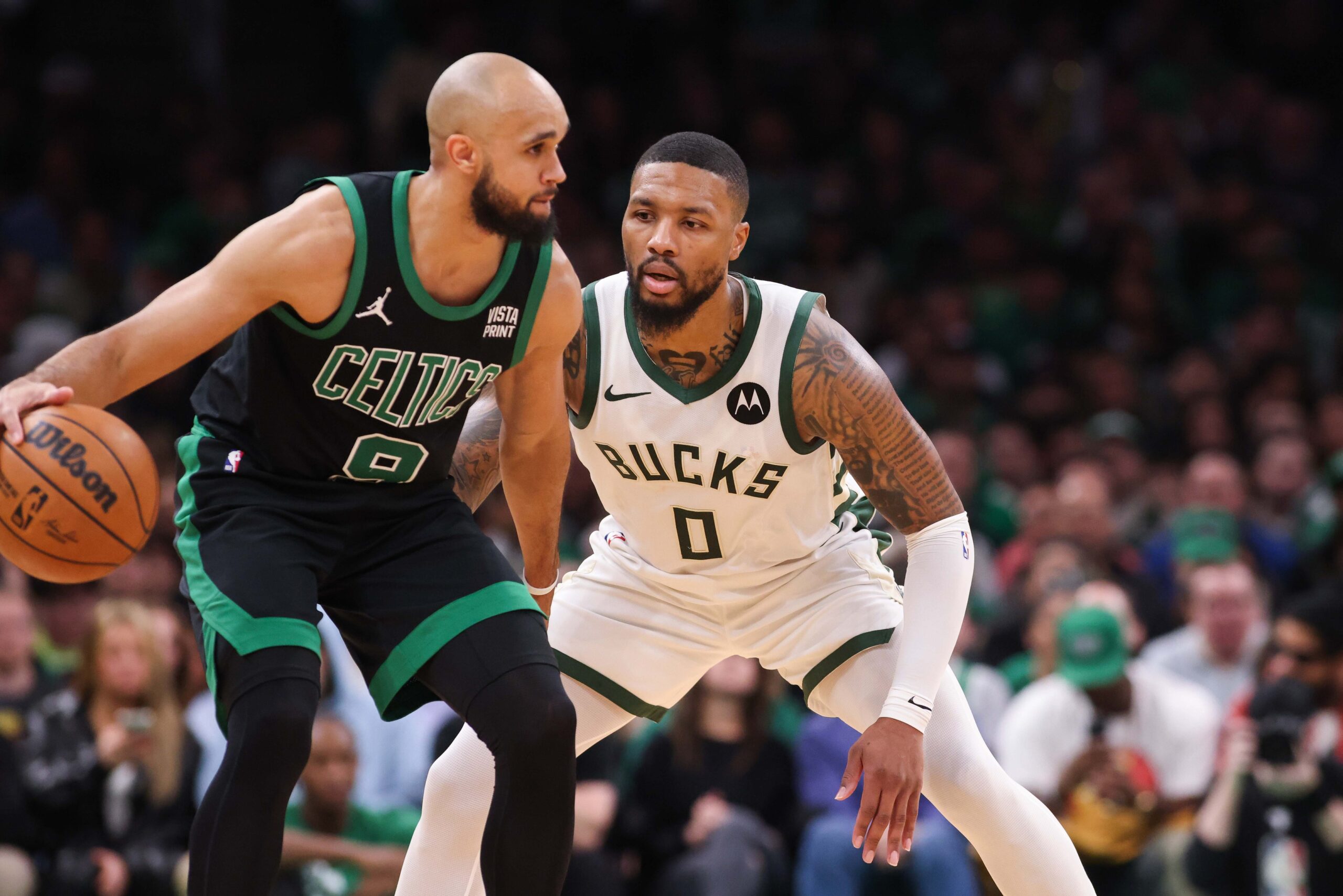 Nov 22, 2023; Boston, Massachusetts, USA; Milwaukee Bucks guard Damian Lillard (0) defends Boston Celtics guard Derrick White (9) during the second half at TD Garden.