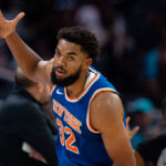 CHARLOTTE, NORTH CAROLINA - OCTOBER 06: Karl-Anthony Towns #32 of the New York Knicks reacts in the first quarter during a preseason game against the Charlotte Hornets at Spectrum Center on October 06, 2024 in Charlotte, North Carolina